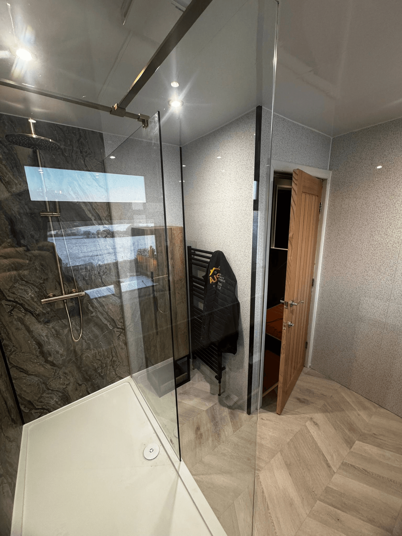 Modern open shower room with stone effect panels