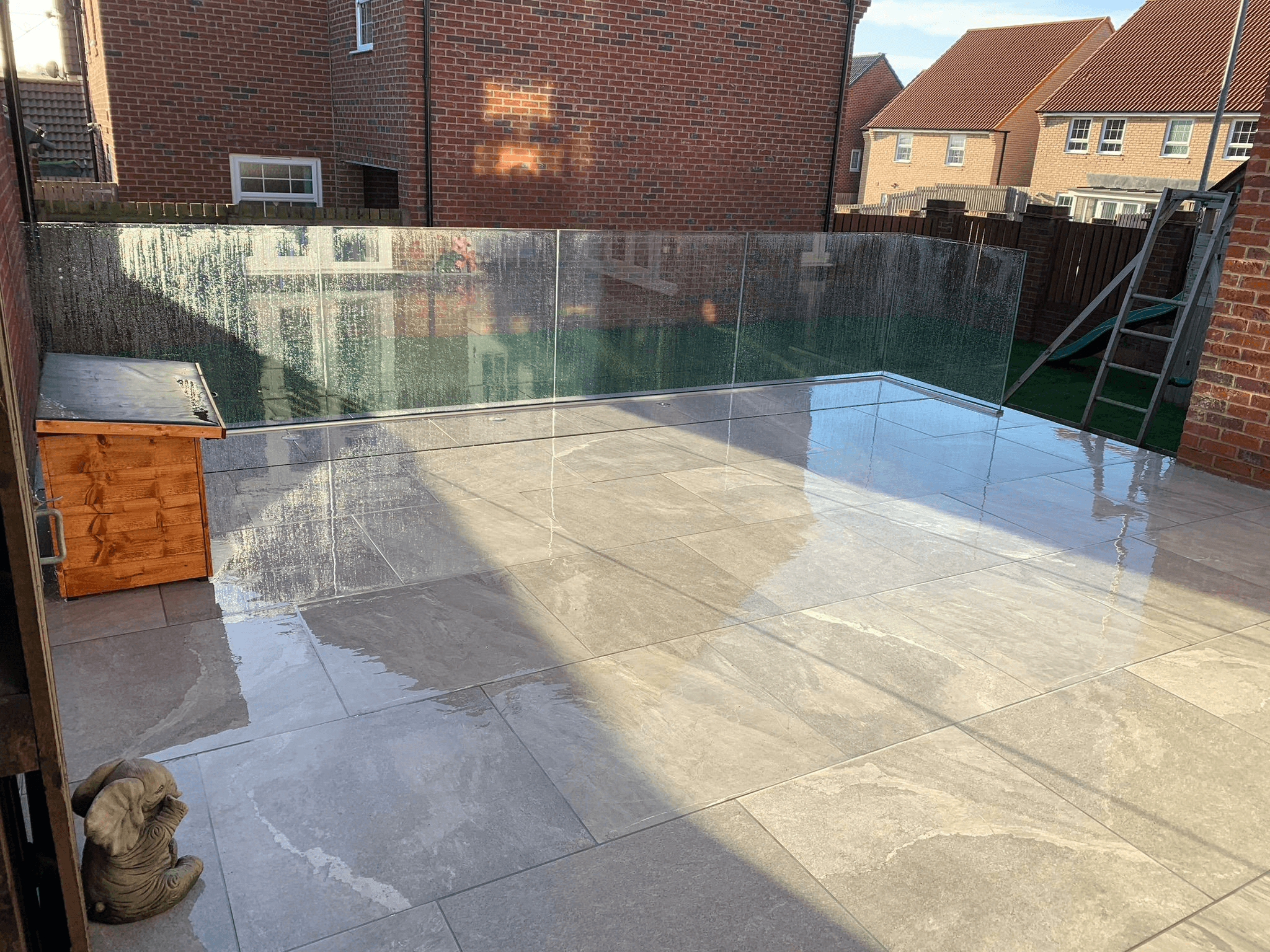 Glass balustrade with porcelain patio tiles